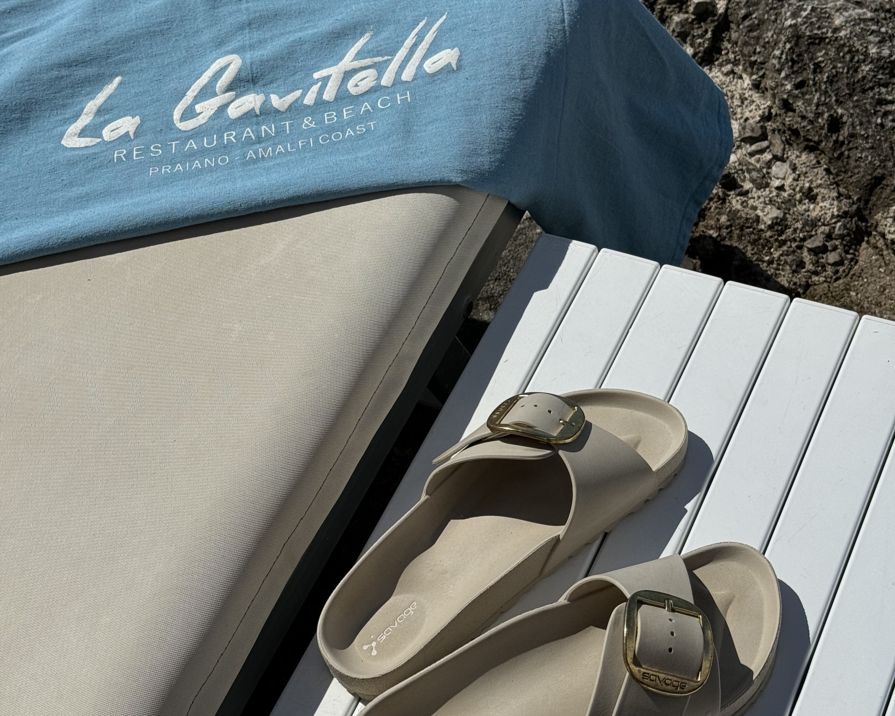 Sandals and La Gavitella tote bag on a sunbed — the right footwear for a day on the Amalfi Coast